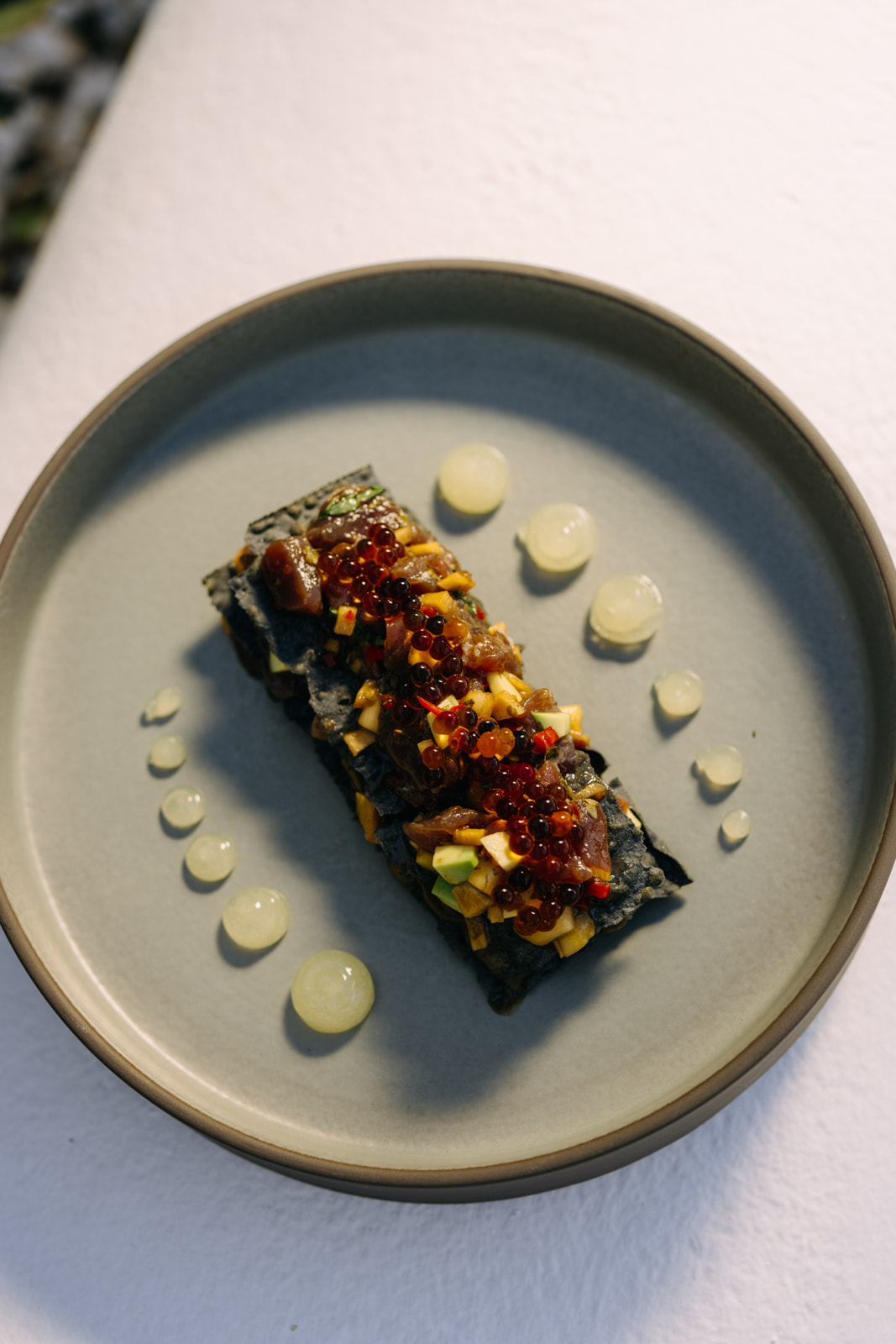 Artistically plated modern Greek dish showcasing local ingredients and innovative presentation